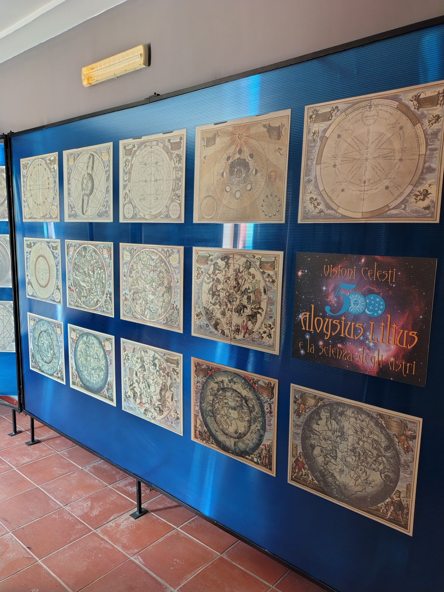 Museum display panel with astronomical charts and celestial imagery